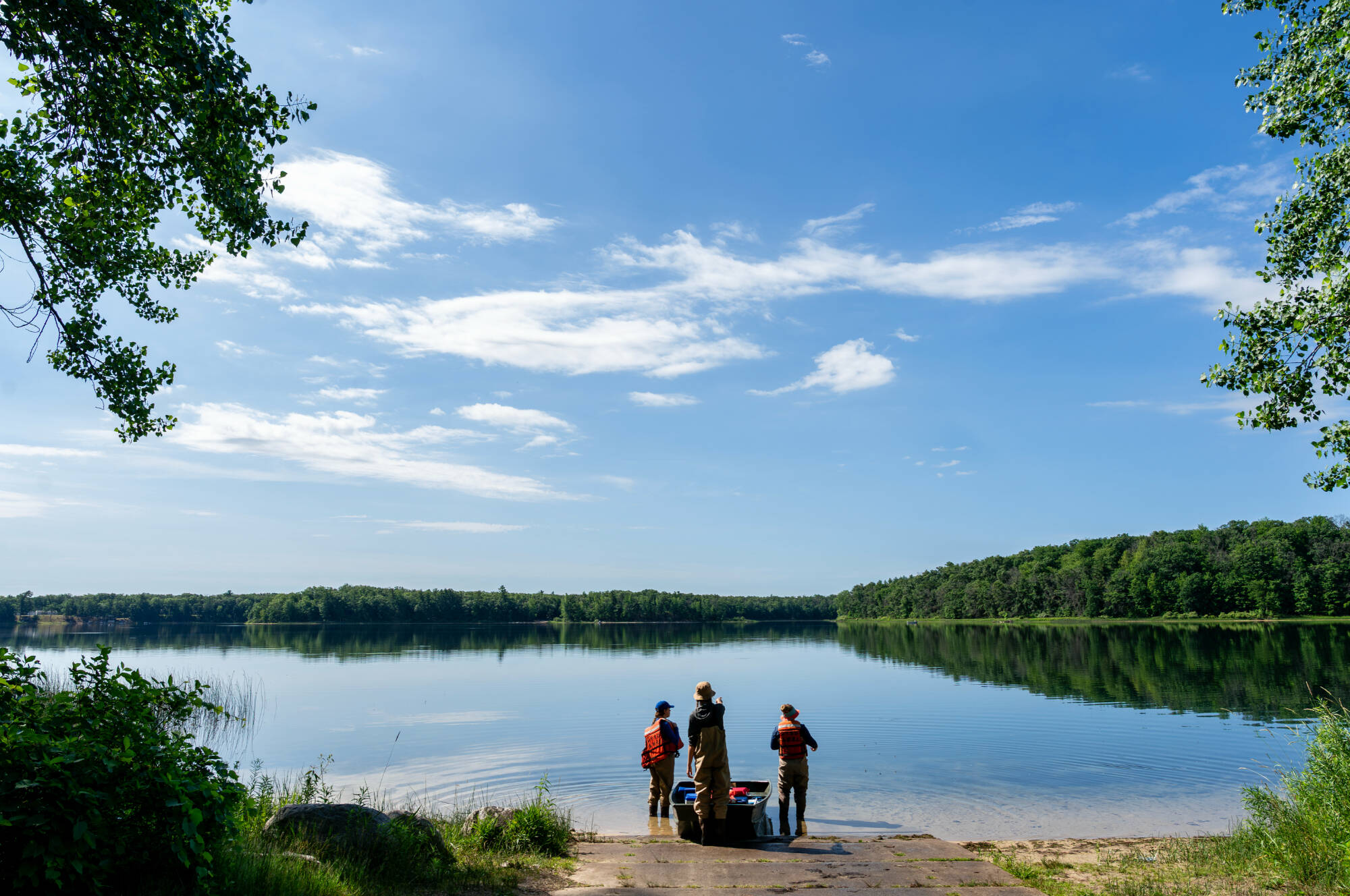 (From left) Alexis Porter, Mya Harmer and Katie Tyrrell, staff members with the Steinman Lab, prepare to launch a boat at Nichols Lake in Newaygo County on June 24. The work is part of AWRI’s inland lake salt survey. (Photo releases on file)